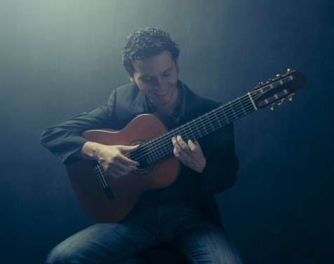 Cesar Garabini holding a guitar